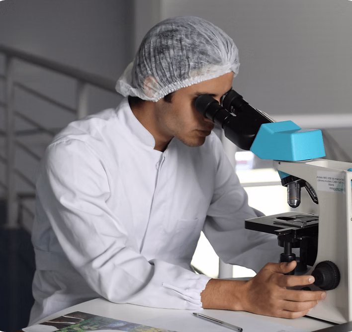 Researcher looking through microscope